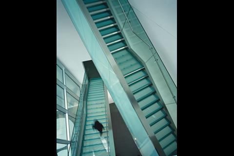 Open staircases pick their way through a spacious day-lit atrium